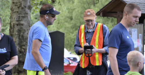Volunteer checking in runner at a race.